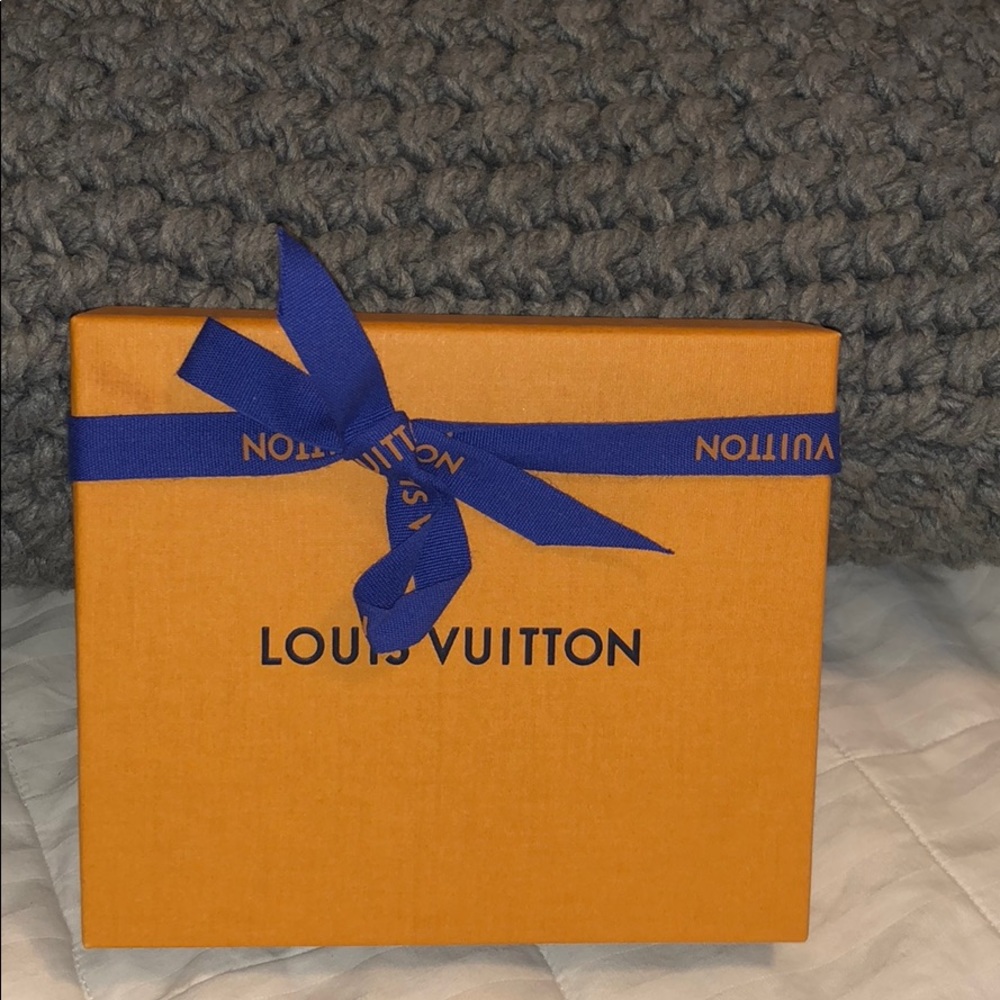 Louis Vuitton black leather strap.